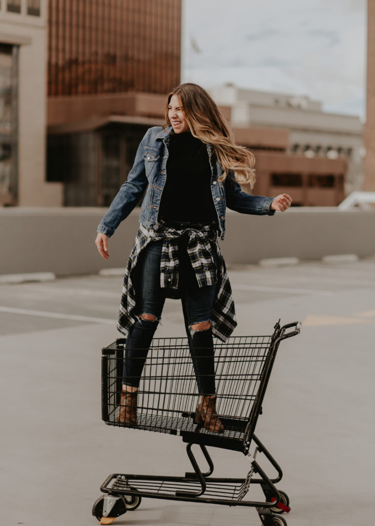Utah fashion blogger riding in a shopping cart for a photoshoot