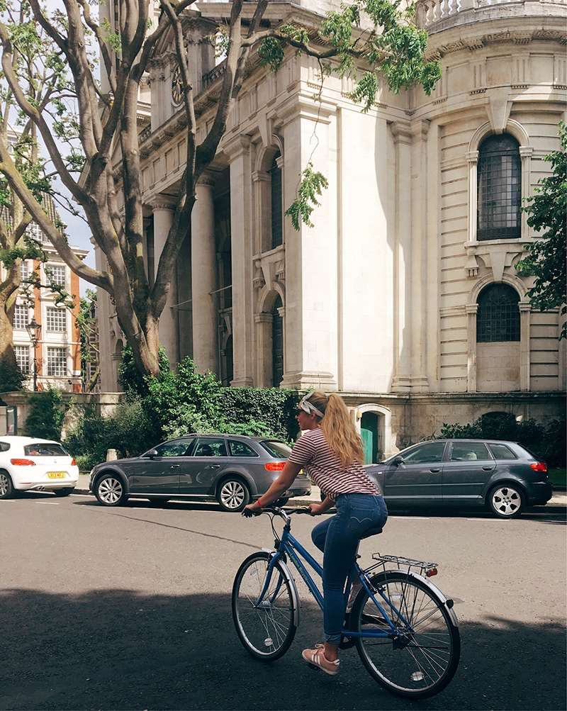 Social Media Influencer, Lauryncakes riding a bike on sunny London street. 