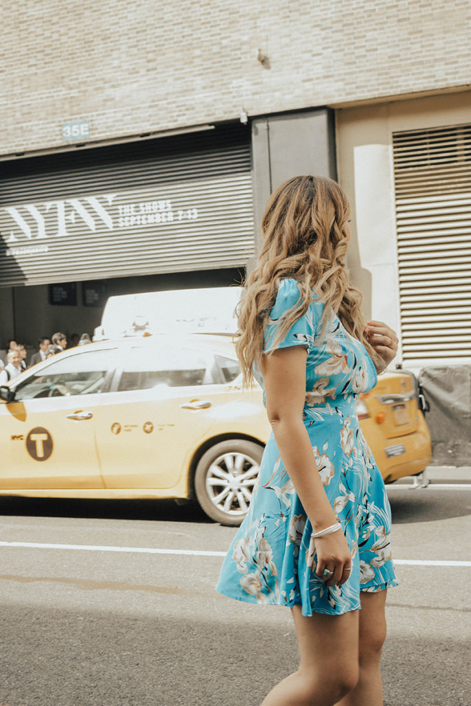 Lauryn Hock walking in front of a taxi near the NYFW venue