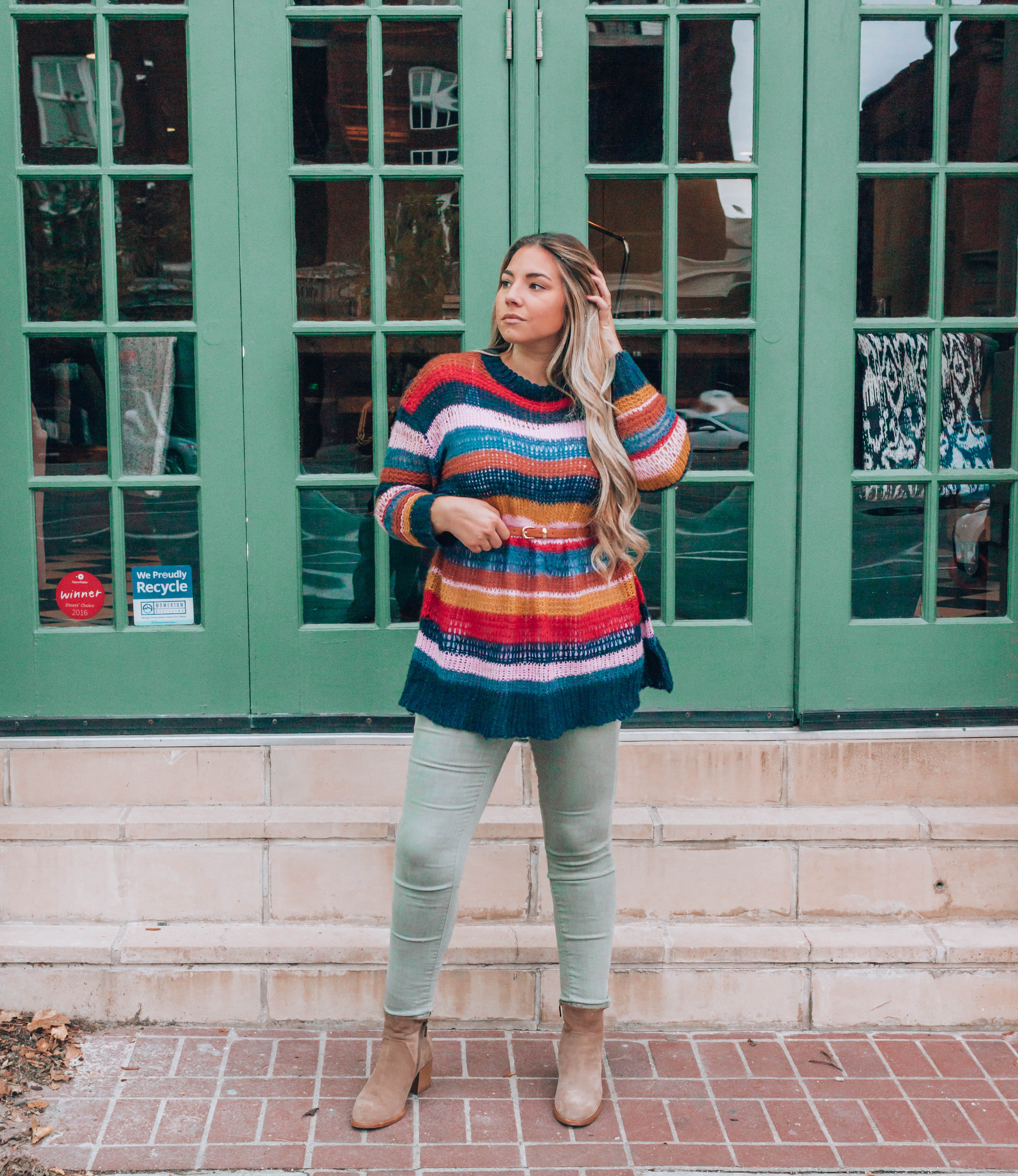 Woman standing outside in fall clothing.