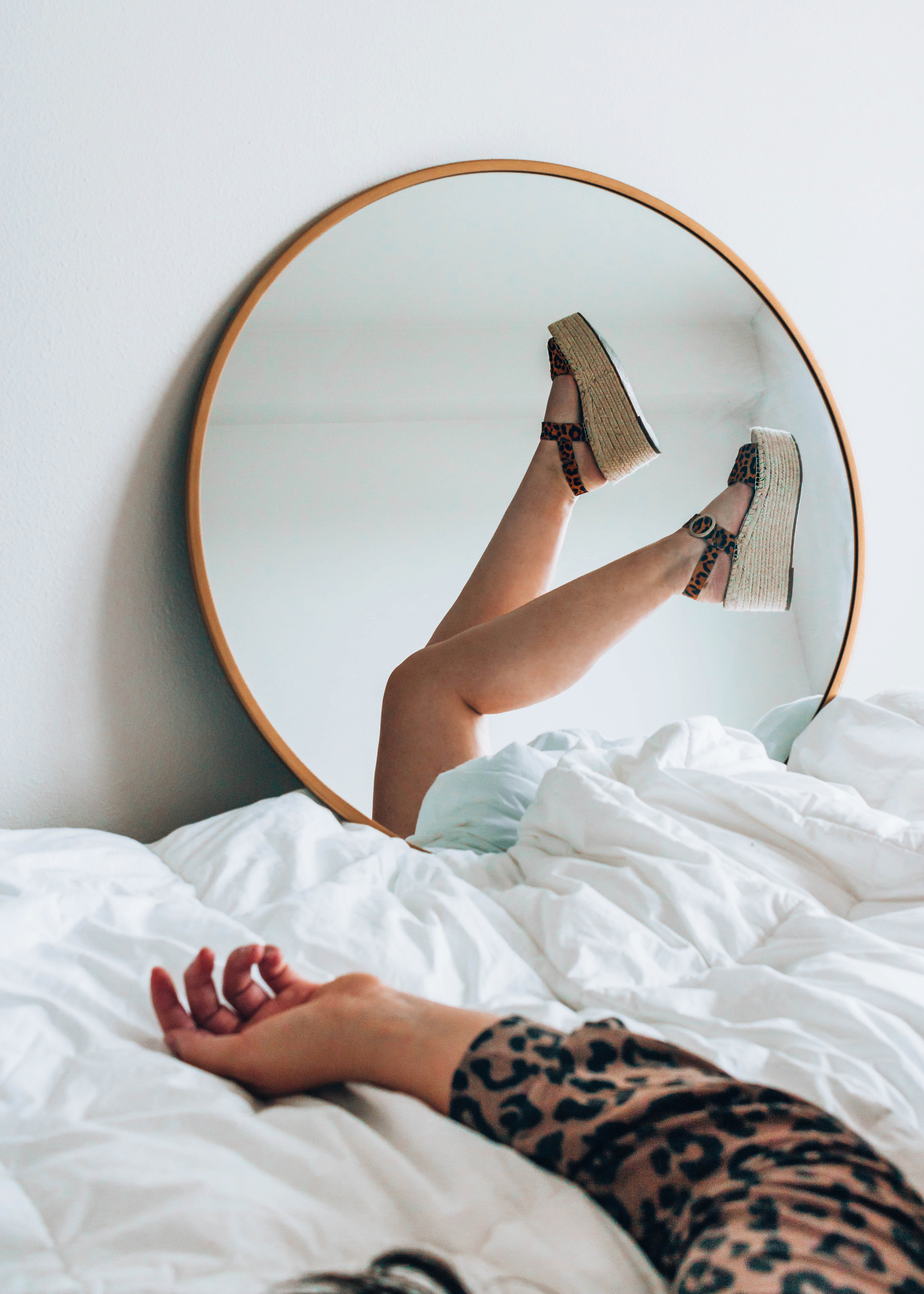 Beauty blogger's legs in a mirror. 