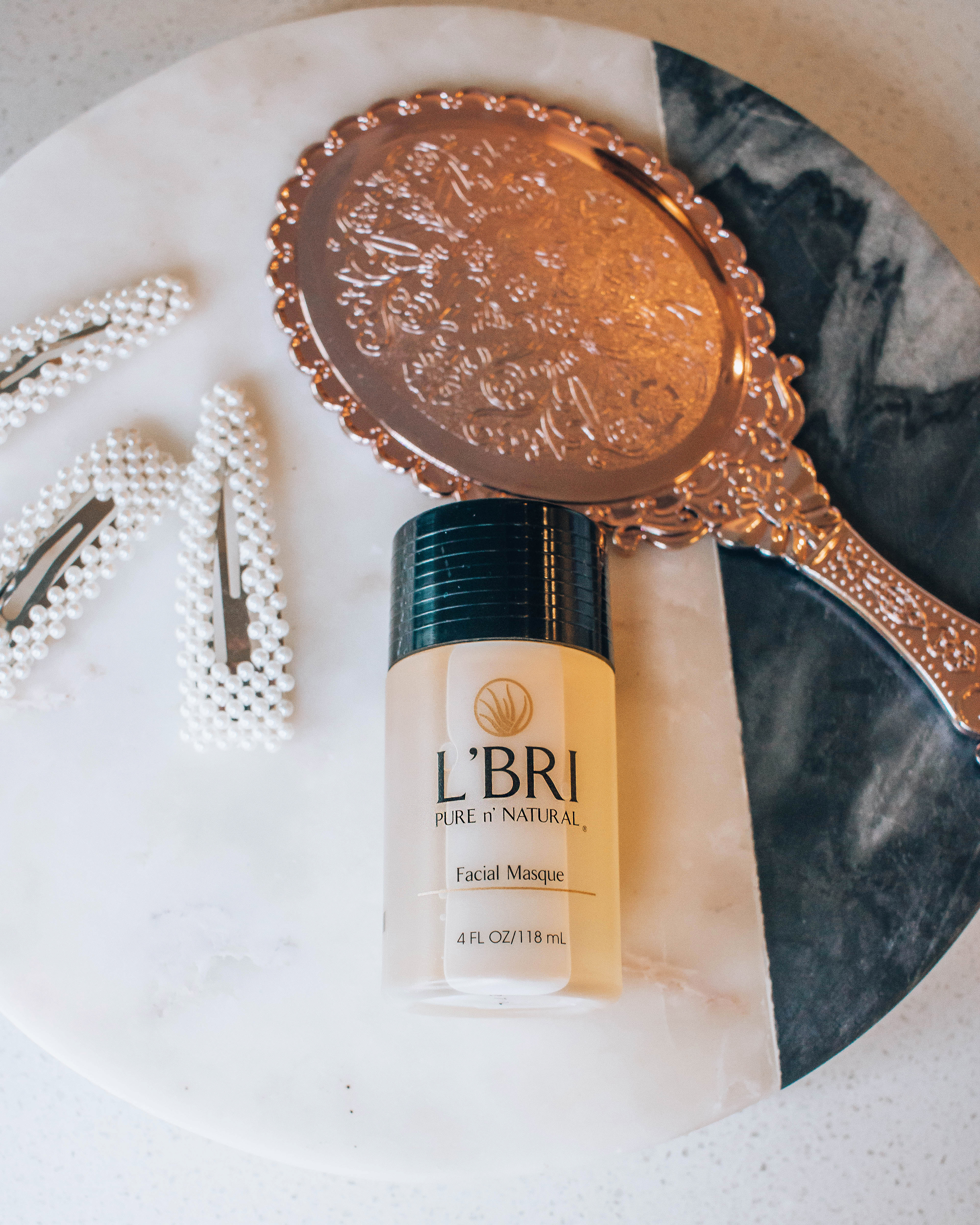 L'BRI Pure n' Natural Facial Mask, flat-lay with other beauty items. 