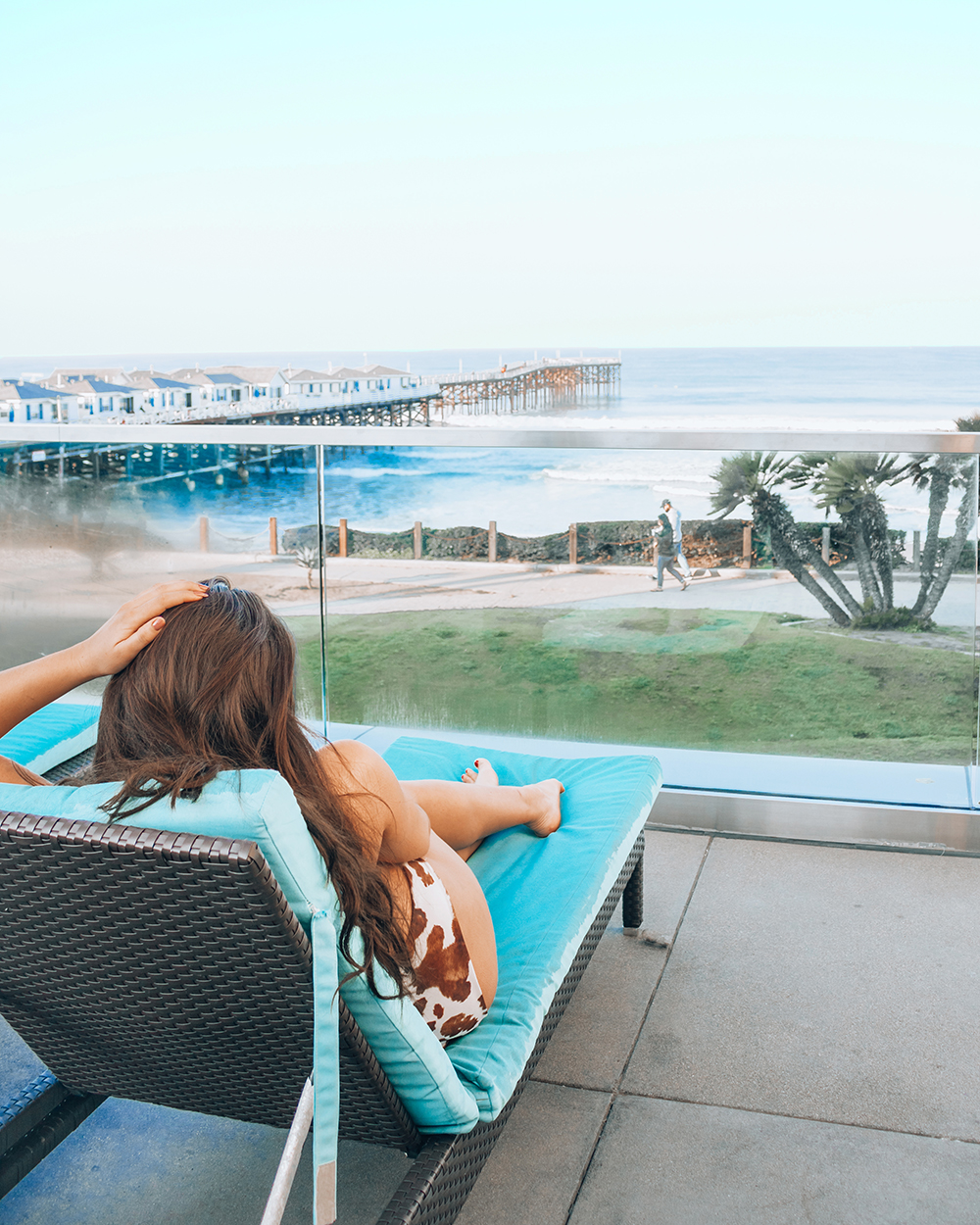 Lauryncakes relaxes on a beach chair at Tower 23 Hotel overlooking Pacific Beach Pier in San Diego, California