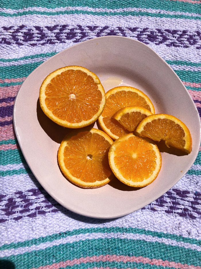 oranges on a plate | benefits of Vitamin C in skincare