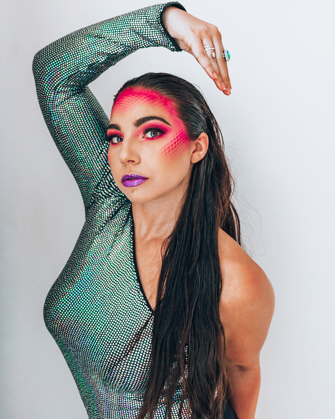 Fishnets create a scale effect with makeup for a DIY snake costume for Halloween 2020