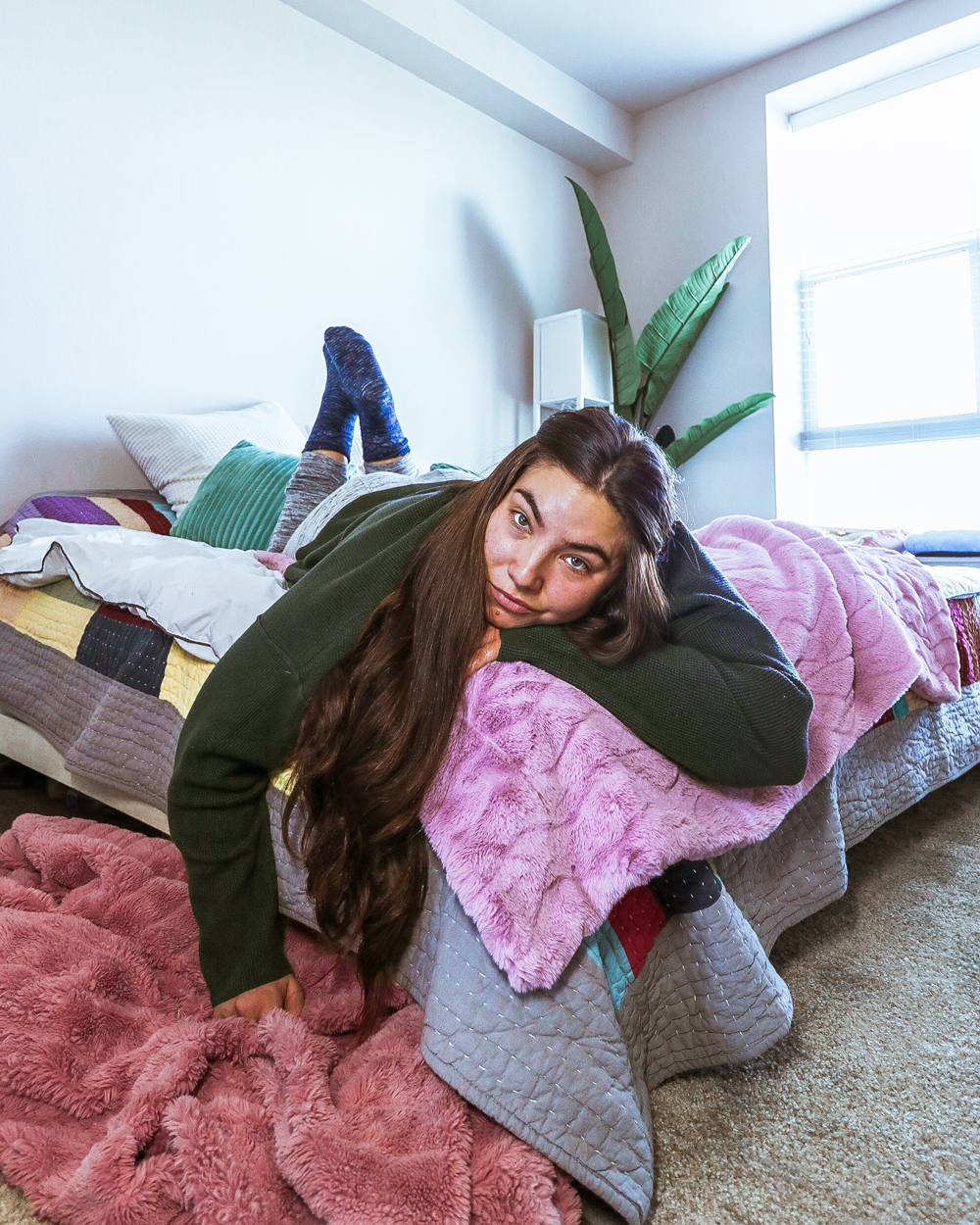 Lauryn Hock in her Salt Lake City apartment bedroom wearing loungewear