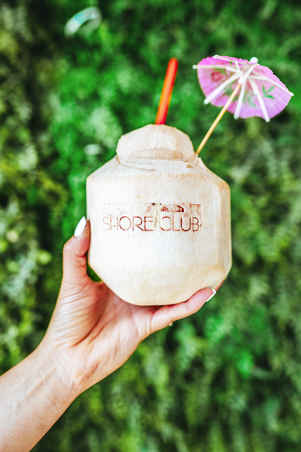 coconut cocktail drink with an umbrella from a beach club and bar in Chicago near the lakeside shoreline