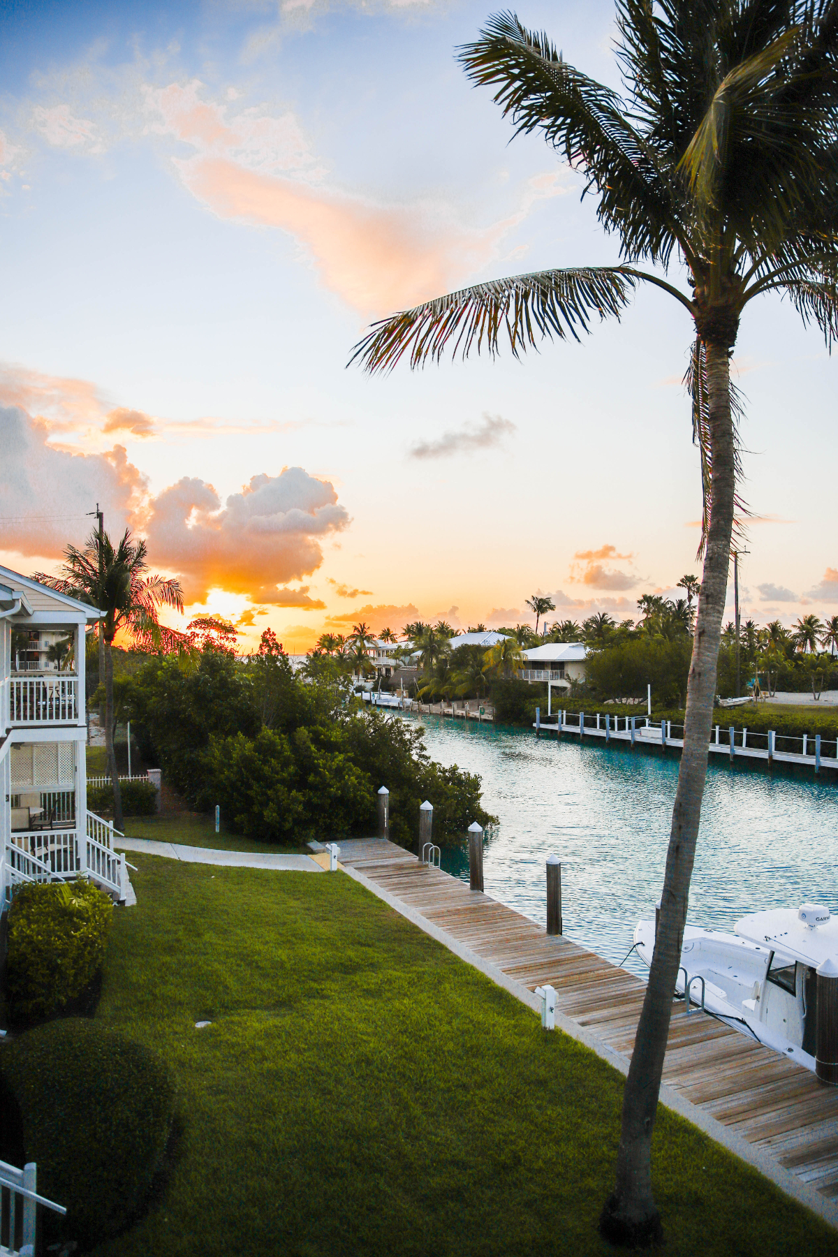 sunrise at Hawks Cay resort showing the bay, grass area, and resort homes